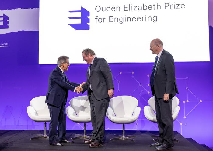 Lord Browne of Madingley FREng FRS, chair of the Queen Elizabeth Prize for Engineering Foundation, left, awards the 2024 Queen Elizabeth Prize for Engineering is today awarded to Denmark’s Henrik Stiesdal, right, and Britain’s Andrew Garrad for advances in the design, manufacture, and deployment of Modern Wind Turbine Technology – the world’s largest rotating machines during the announcement event at the Science Museum in London, UK, on Tuesday, Feb. 6, 2024. Photographer: Jason Alden/QEPrize